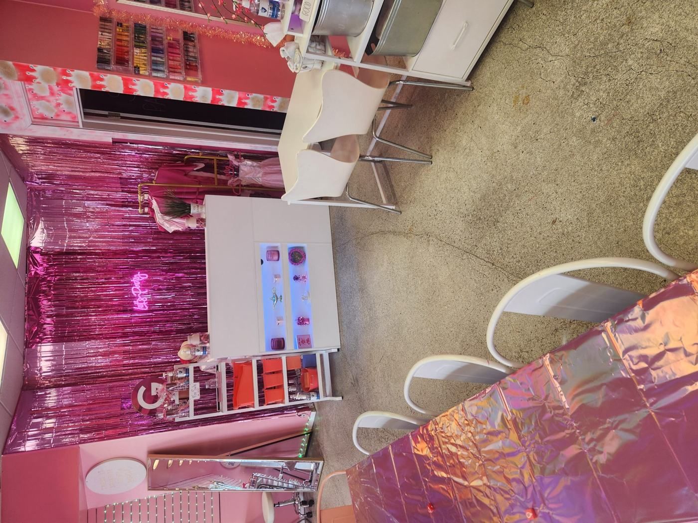 Reception and lounge area with pink tinsel backdrop at My Princess Spa Omaha